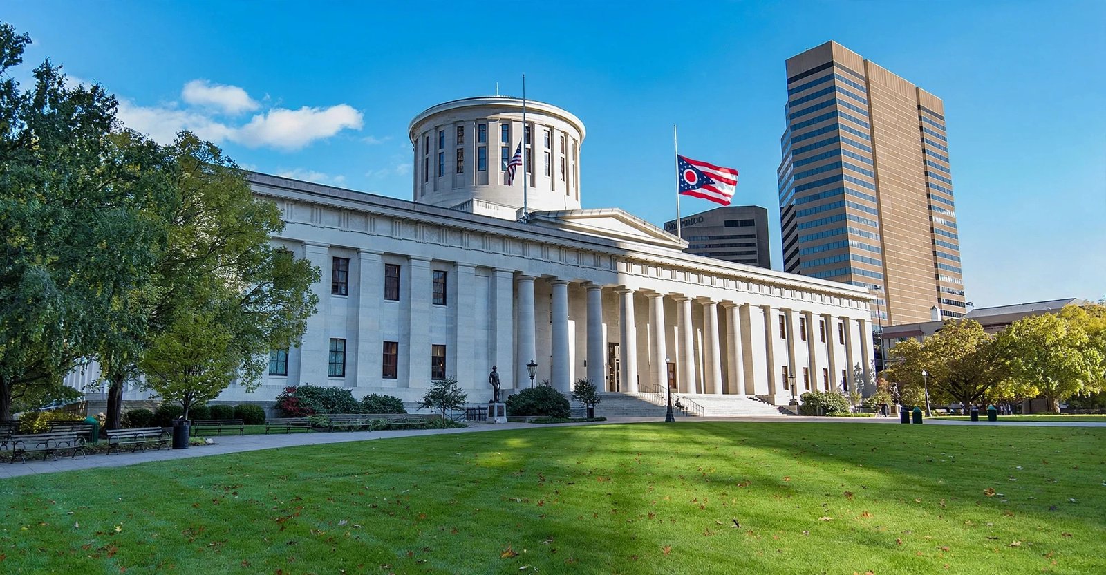 Ohio Statehouse in Columbus with the state flag flying — is Ohio a state? Yes, it is