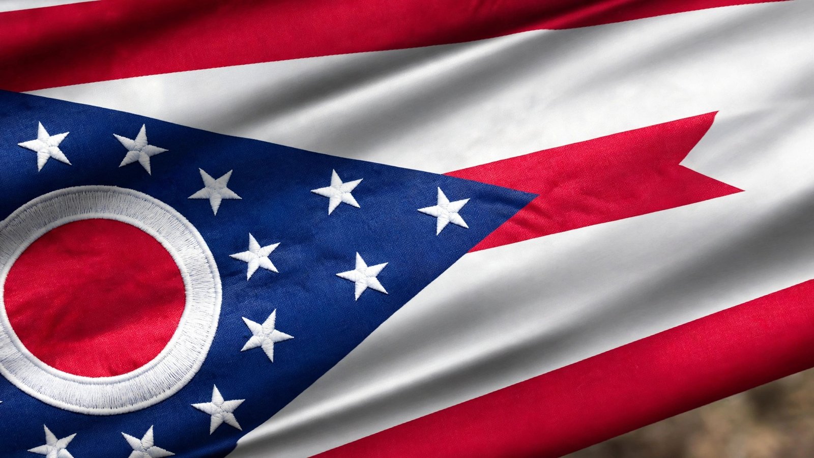 Close-up of the Ohio state flag's blue triangle with 17 stars and the red disc O